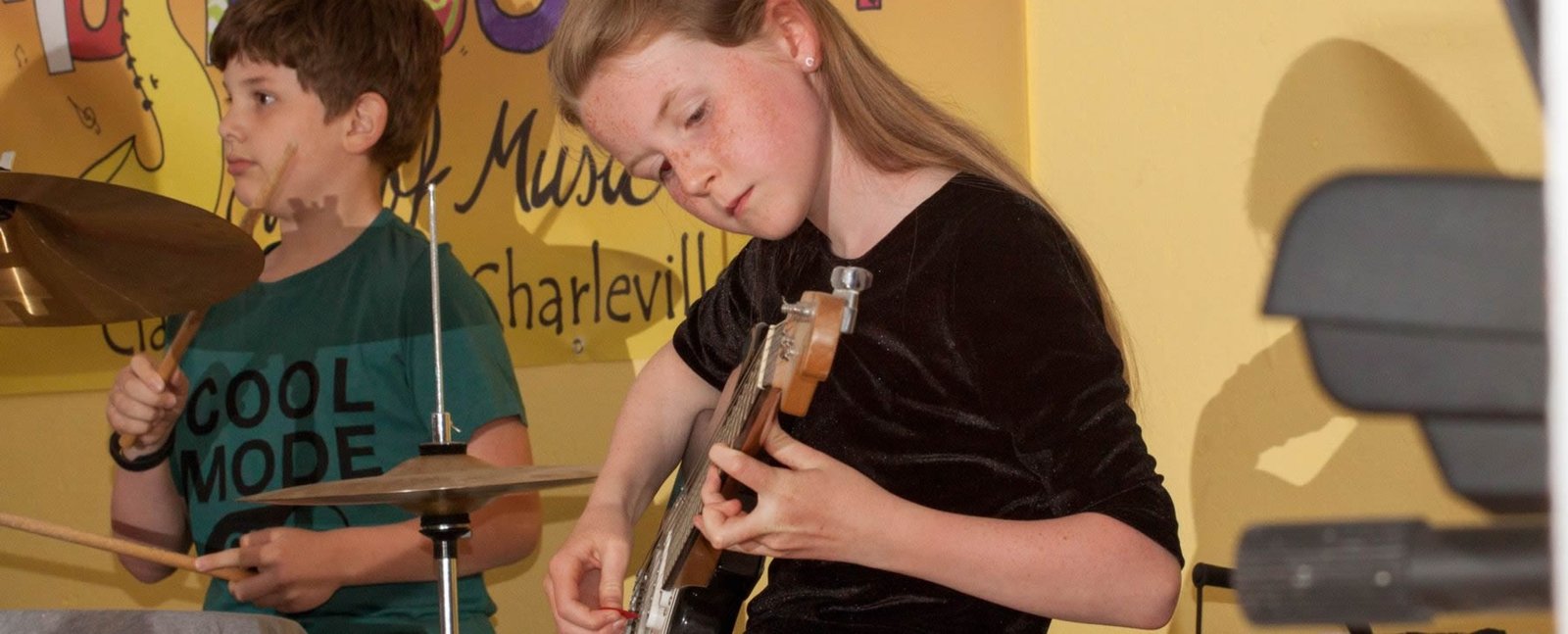 Student choosing an instrument at Musica Fusion